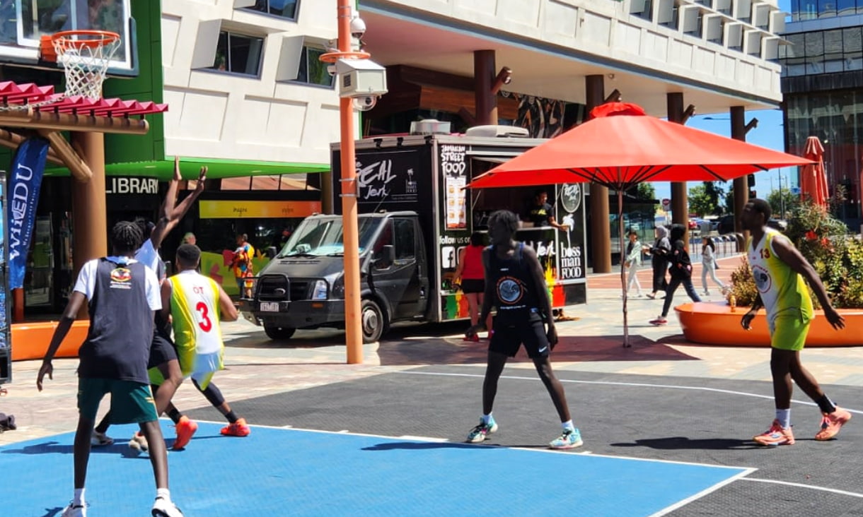 students playing basketball outside at the RMIT campus