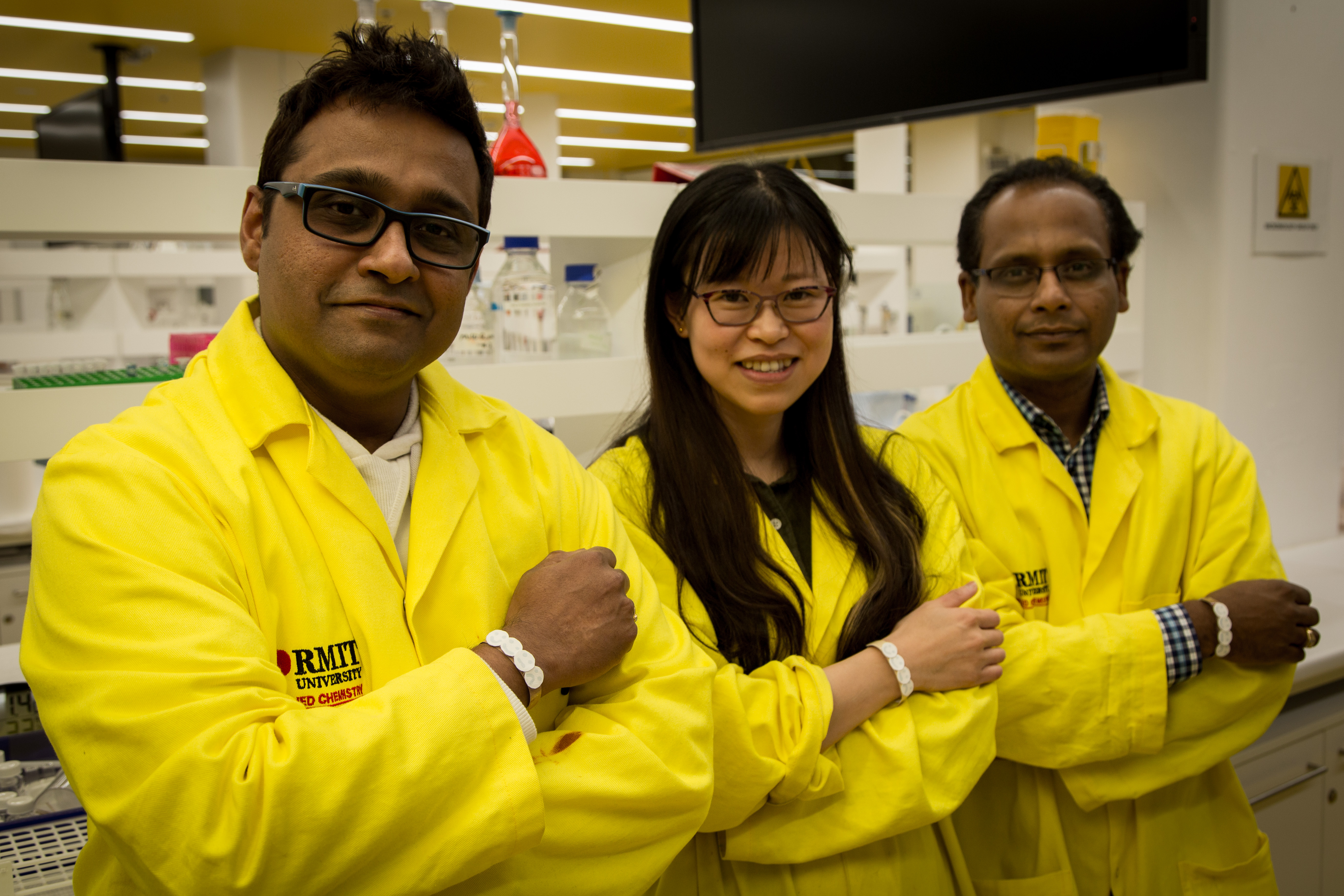 RMIT researchers from the Ian Potter NanoBioSensing Facility wearing prototypes of their UV sensor, from left to right, Dr Rajesh Ramanthan, PhD candidate Wenyue Zou and Professor Vipul Bansal.