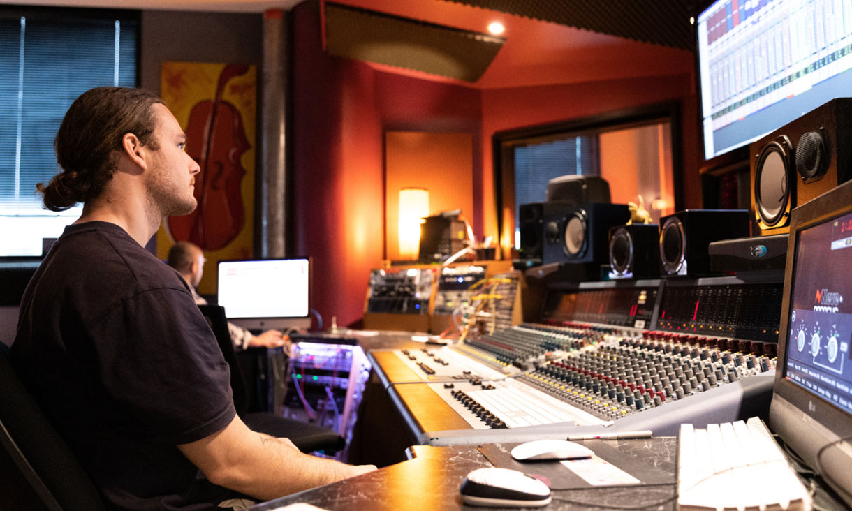 Student Marcus Raymond sits at recording desk