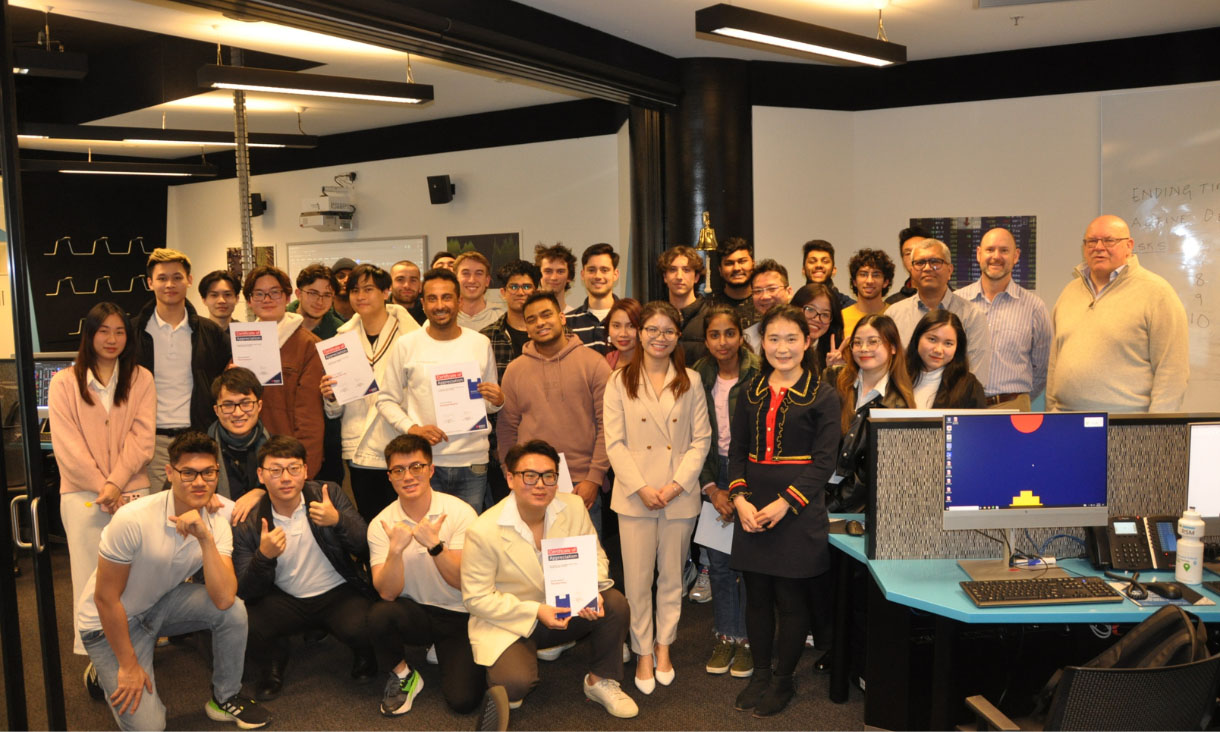 35 students crowded in the Trading Facility with certificates of participation