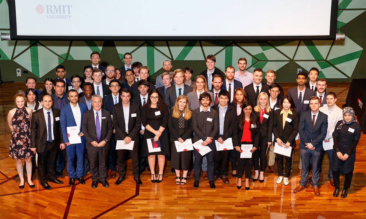 The nearly 70 winners of the 2019 School of Engineering Prizes standing on stage holding their certificates.