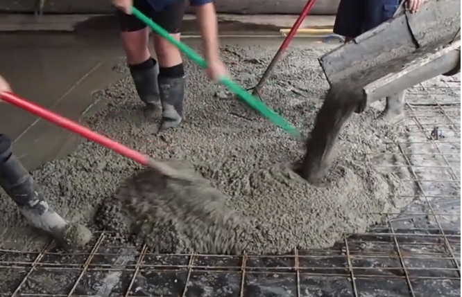 Spreading the Polyrok concrete.