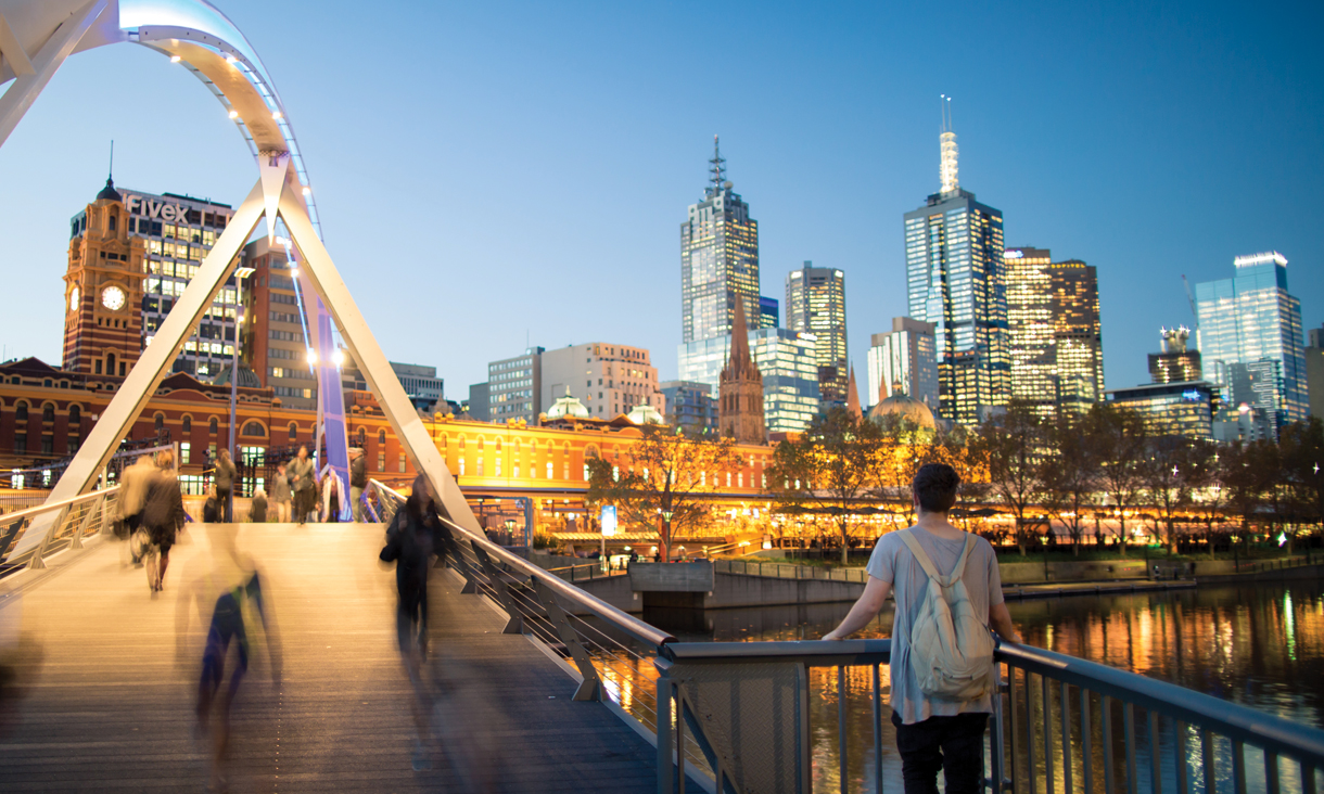 Student looking at Melbourne skyline at night