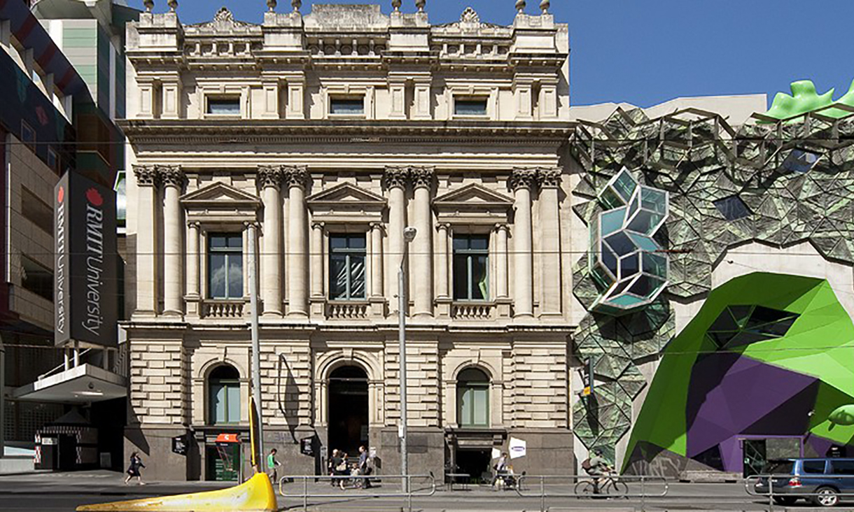 A photo of Storey Hall, the building RMIT Gallery is housed in. It's a sandstone building built in 1887 in a classic style with columns.