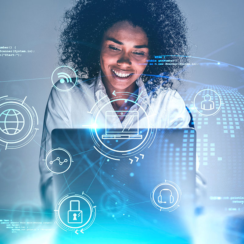 Person working on a laptop with digital icons overlaid, symbolising cybersecurity, communication, and global connections.