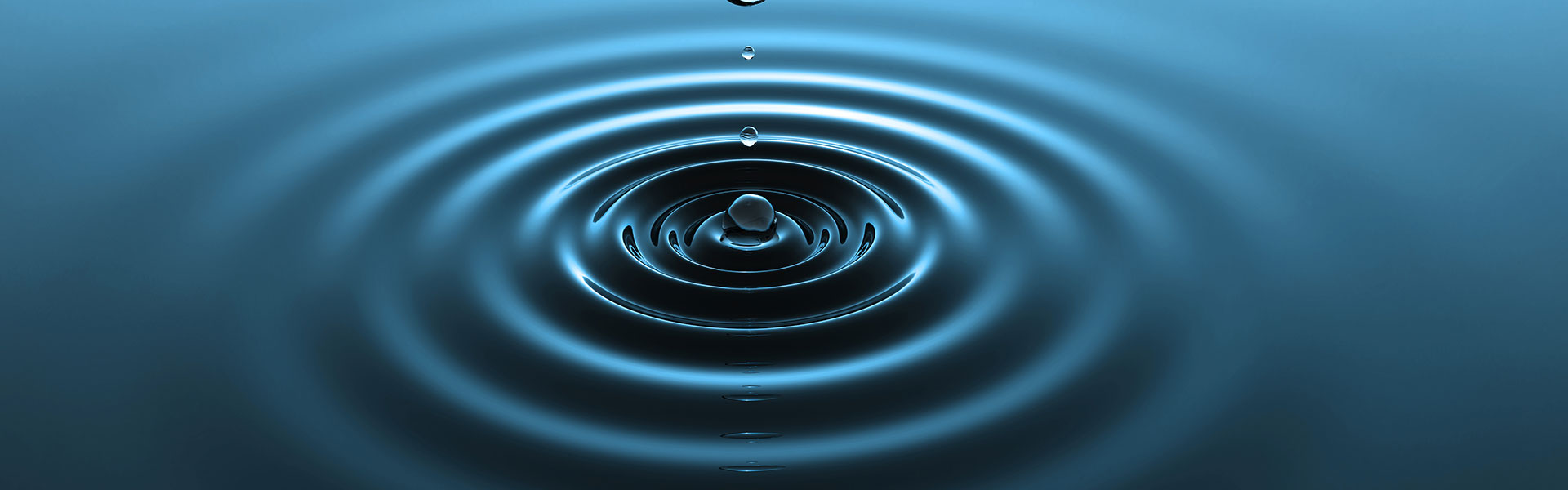 Drop of water falling into water