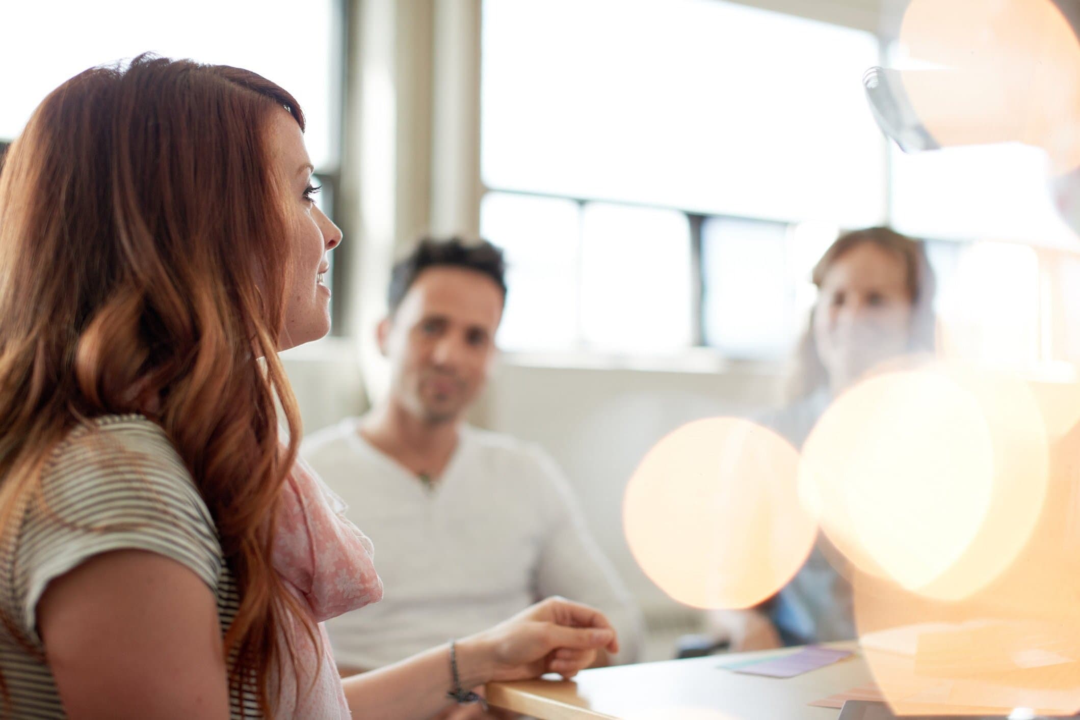 Unposed group of creative business people in an open concept office brainstorming their next project.