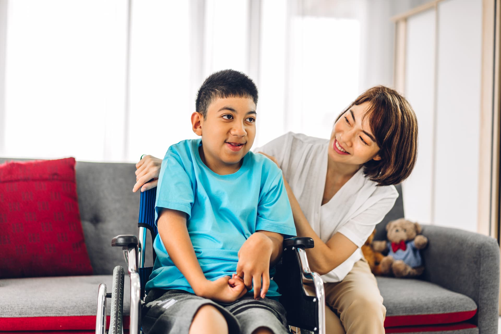 Woman sitting next to child in wheelchair