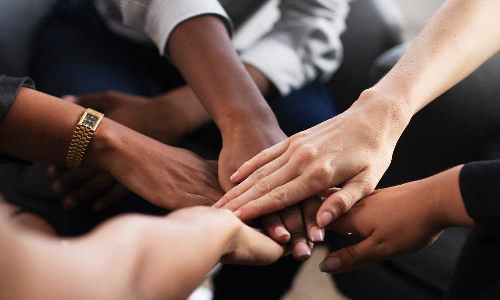 Group of hands stacked on top of each other