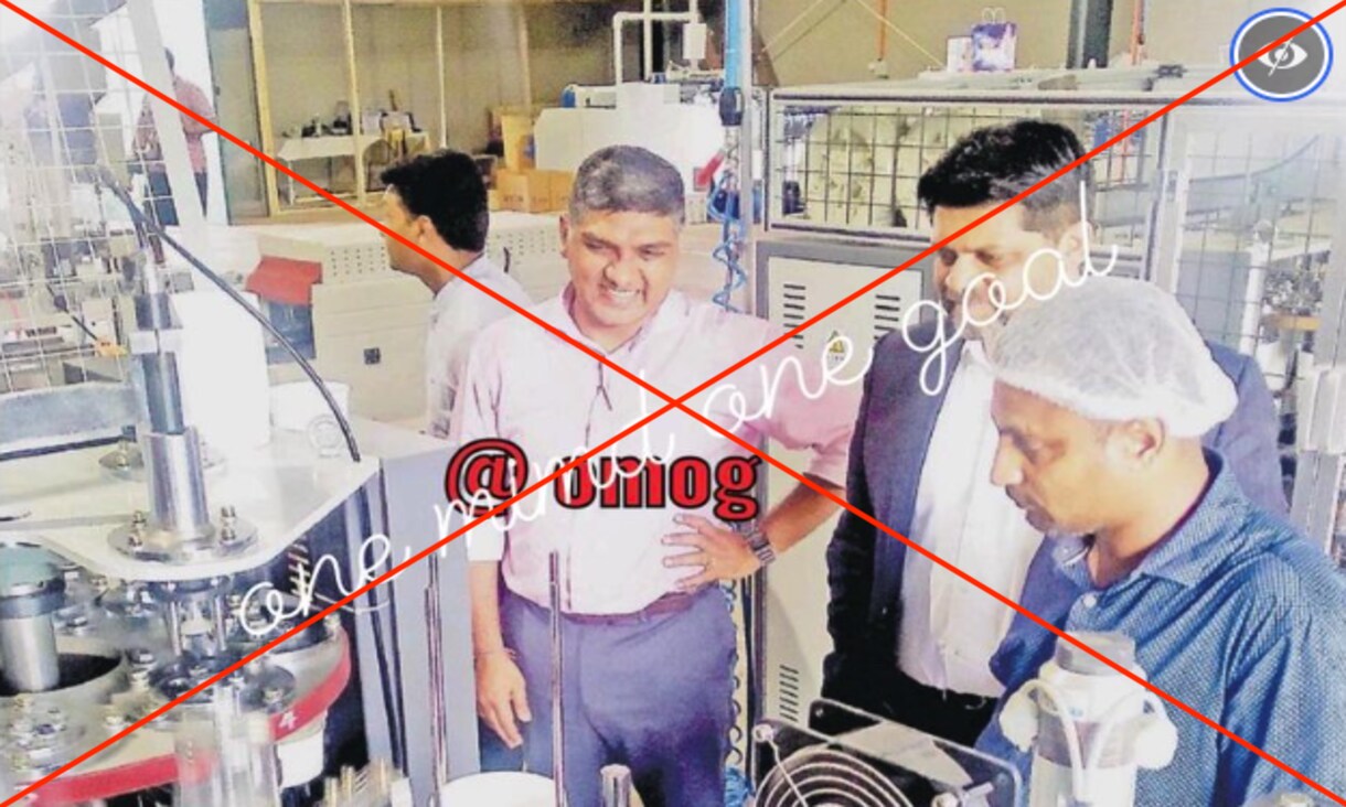 Fiji’s Attorney-General at a printing facility standing next to two other men.