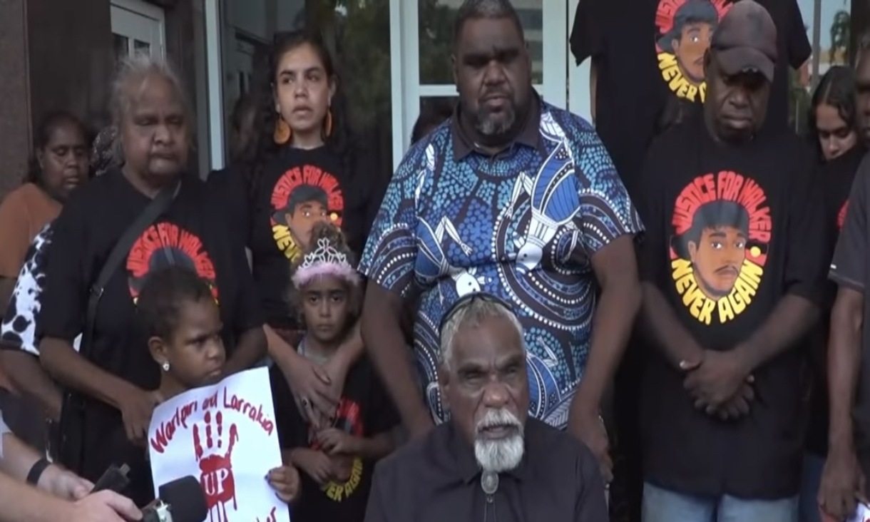 Ned Jampijinpa Hargraves surrounded by friends and family wearing 'Justice for Walker' T-shirts