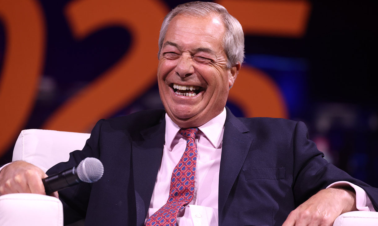 Reform UK leader Nigel Farage laughing during a political conference