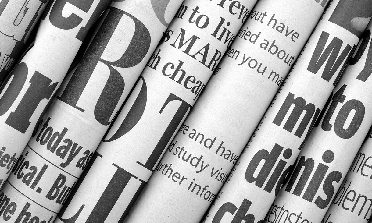 A stack of several folded newspapers
