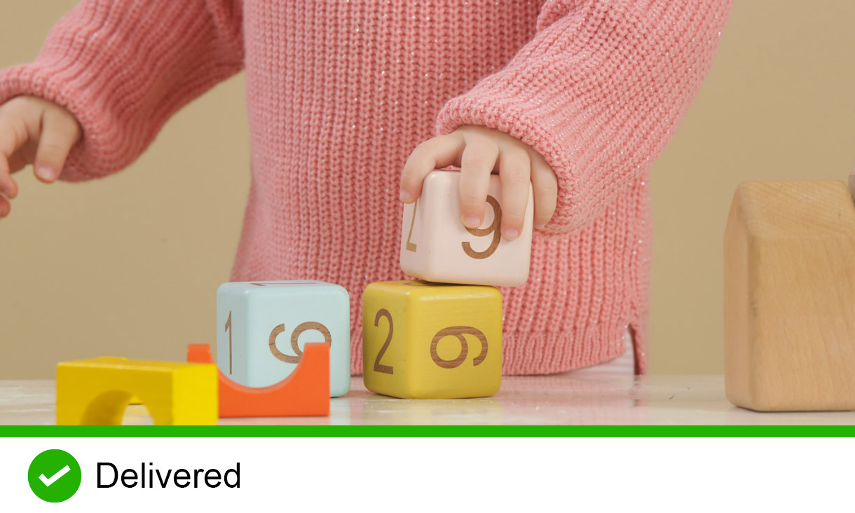 Toddler girl playing with wooden blocks