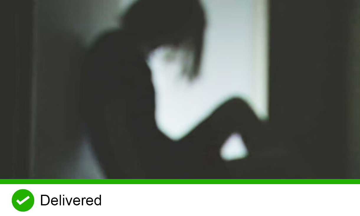 Blurry silhouette of person sitting down