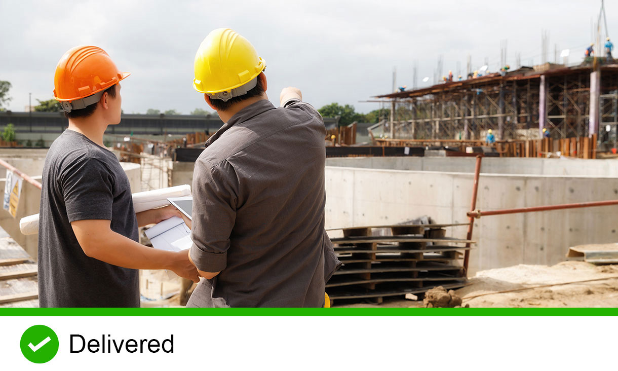 Two construction workers on building site