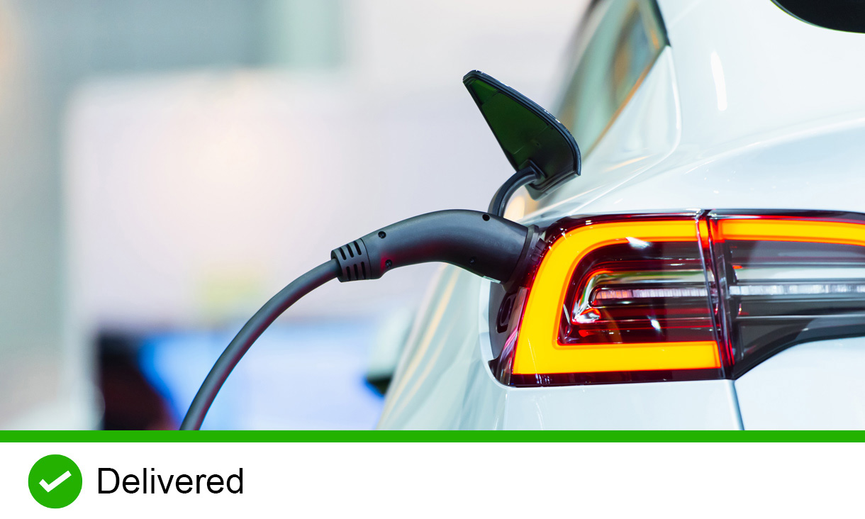 Close up of the Hybrid car electric charger station with power supply plugged into an electric car being charged.