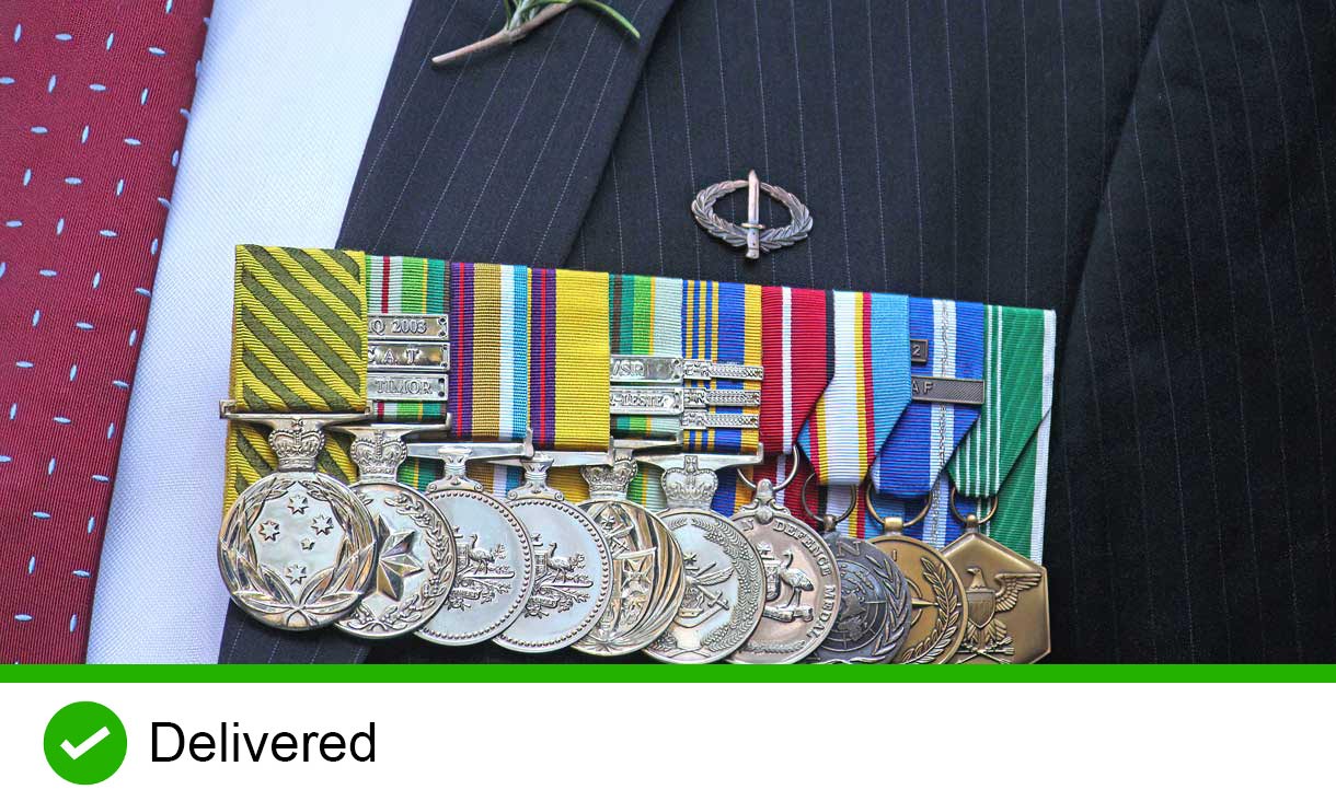 Anzac Day March. Man wearing a suit, tie and medals on his chest