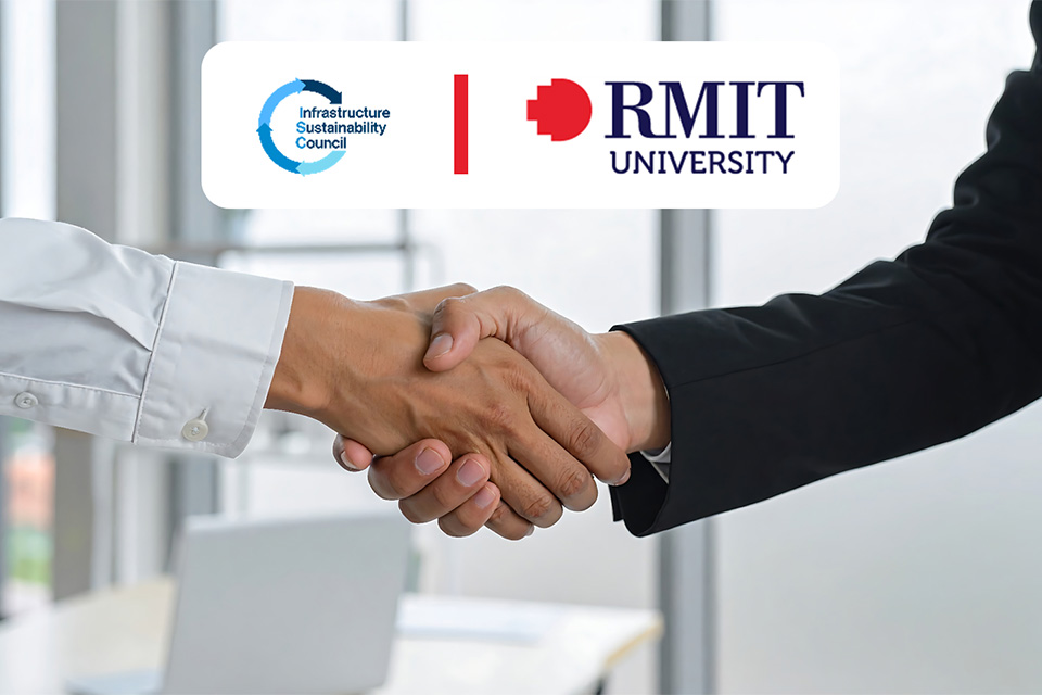 Two people in business attire shaking hands, with the Infrastructure Sustainability Council and RMIT University logos displayed above them.