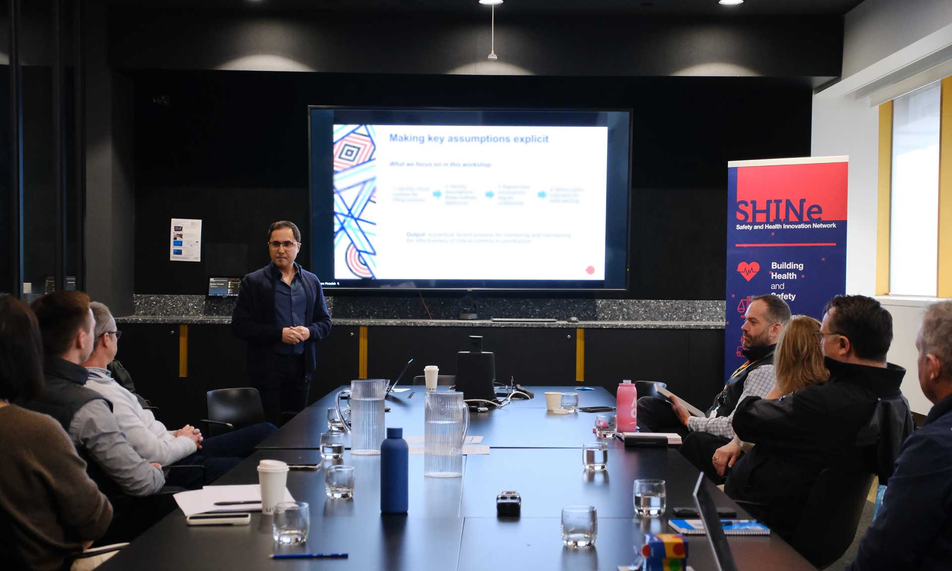 Person presenting to a group of people in a meeting room