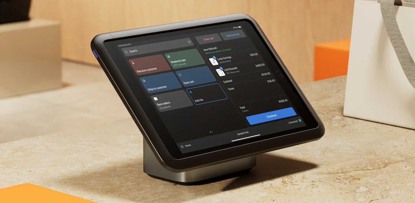 A tablet-based retail point-of-sale system sits on a countertop