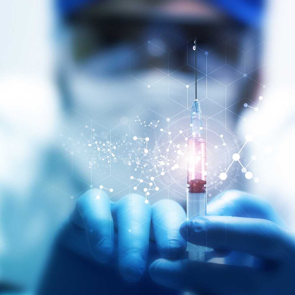 Scientist holding syringe