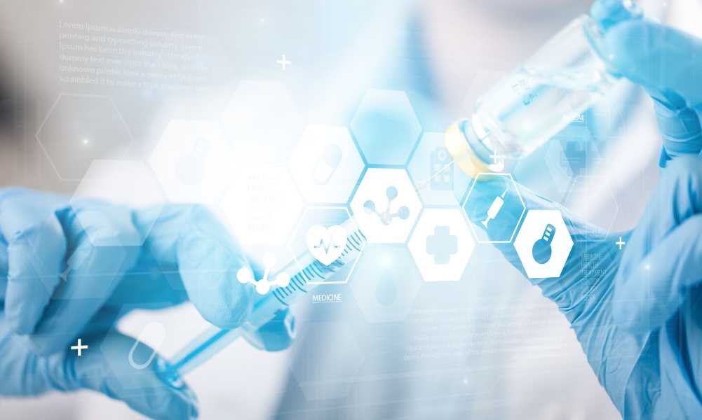 syringe in vaccine bottle beind held