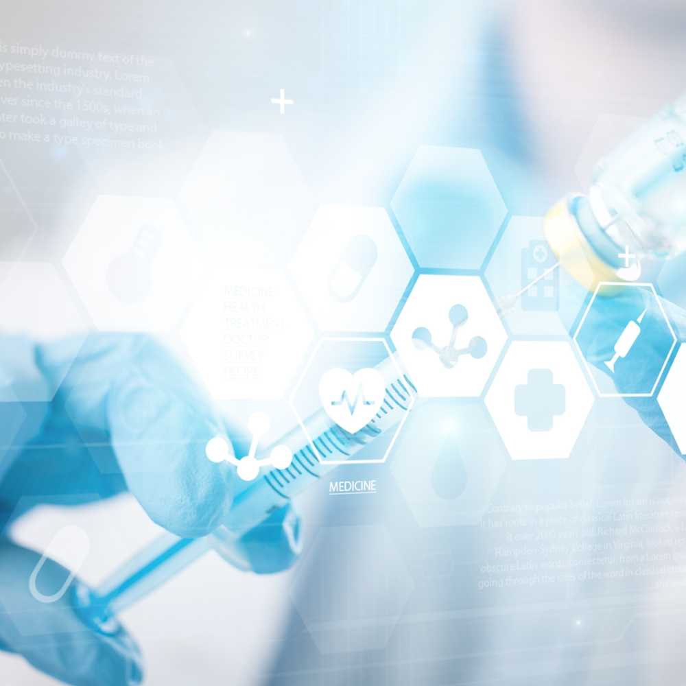 syringe in vaccine bottle beind held