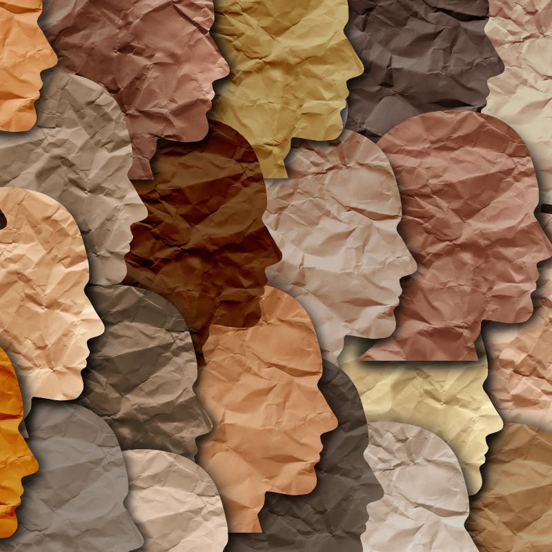Overlapping paper cut-out profiles in various skin tones.