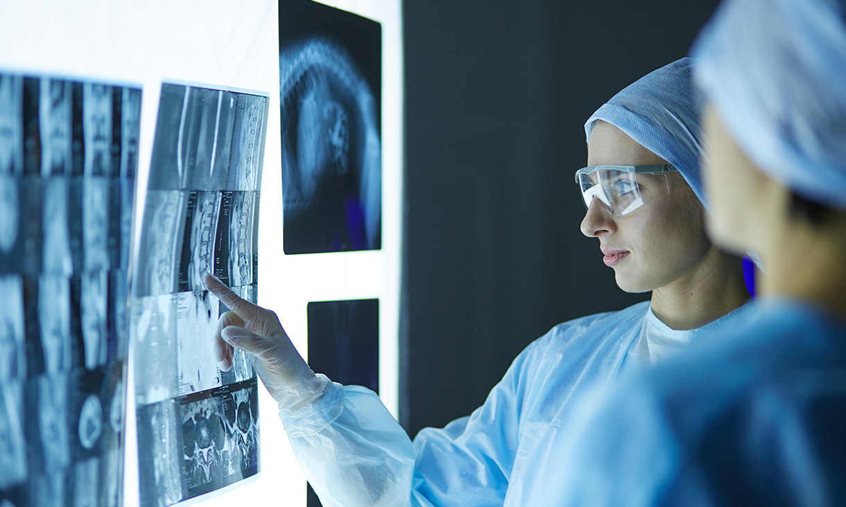 Two female women medical doctors looking at x-rays in a hospital