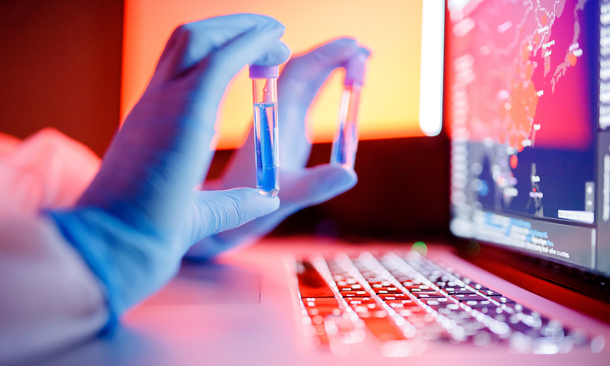 Nurse hold blood test tube in white hazmat protective suit in laboratory computer. Concept study antidote against epidemic