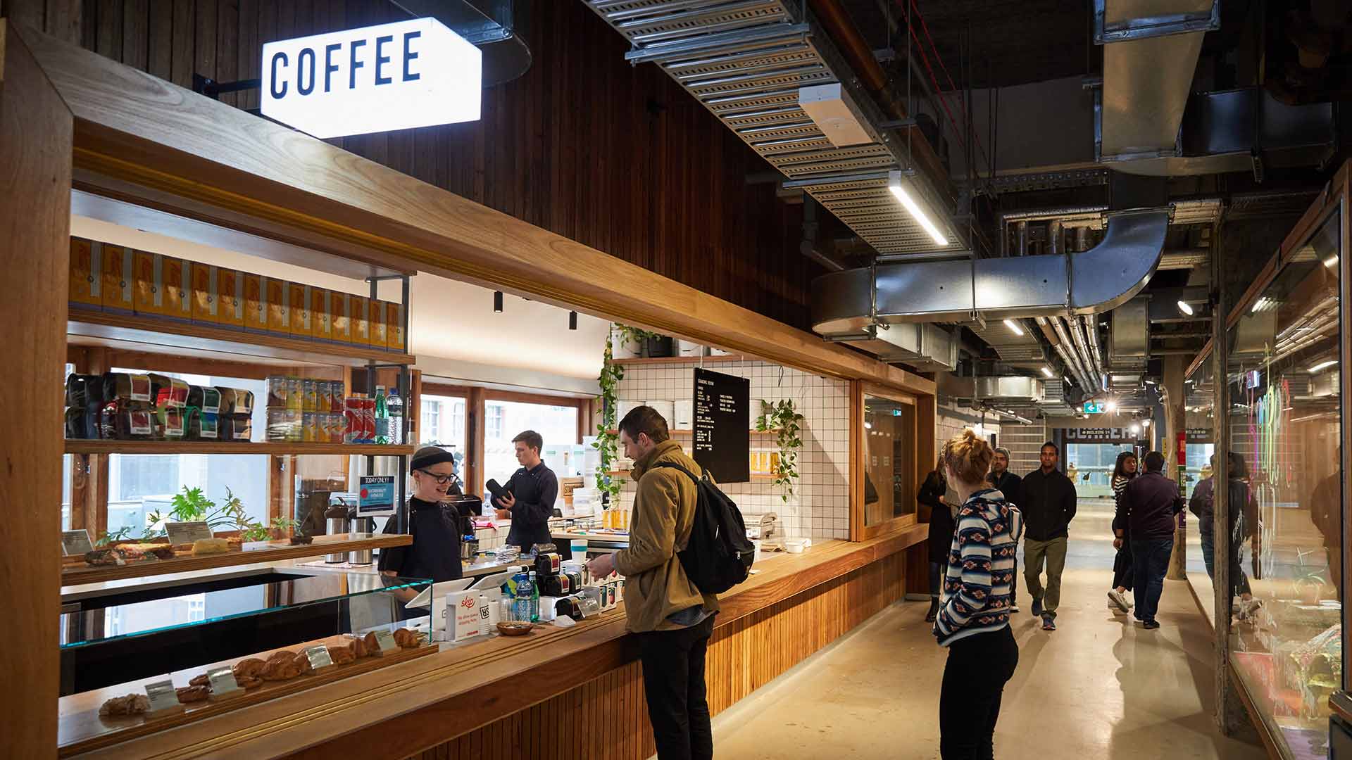 Image of fresh vegetables with a sign above saying 'ethical is the new normal'