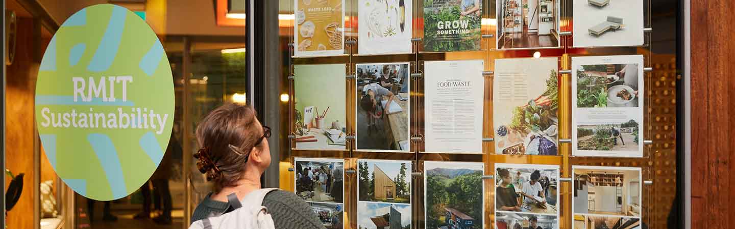Student looking at sustainability posters