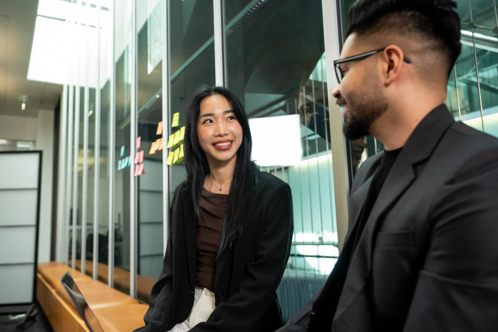 A mentor and an RMIT alumnus sit together with a laptop in discussion