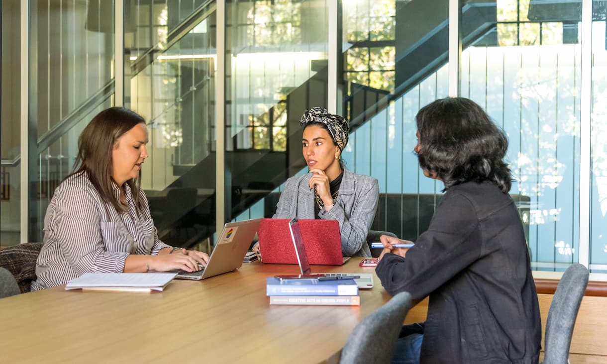 A resume and laptop laid on a tabletop