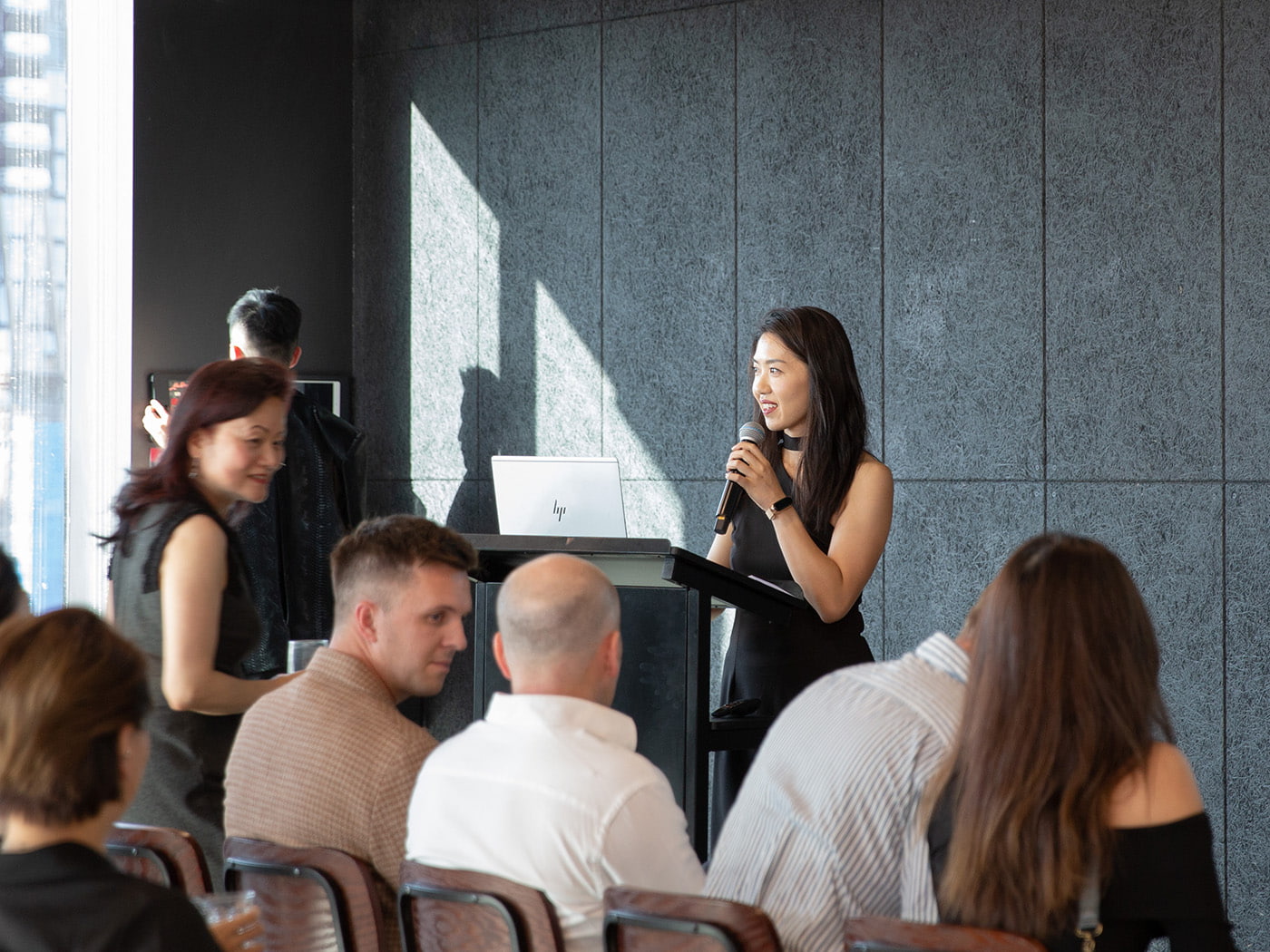 Christine Ding speaking to a crowd.