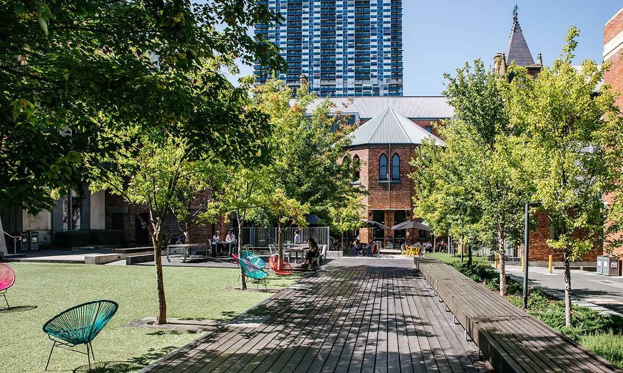 Outside an RMIT building with trees lining the footpath