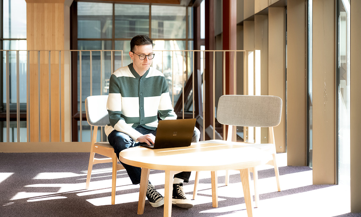 A person working at a desk on a laptop
