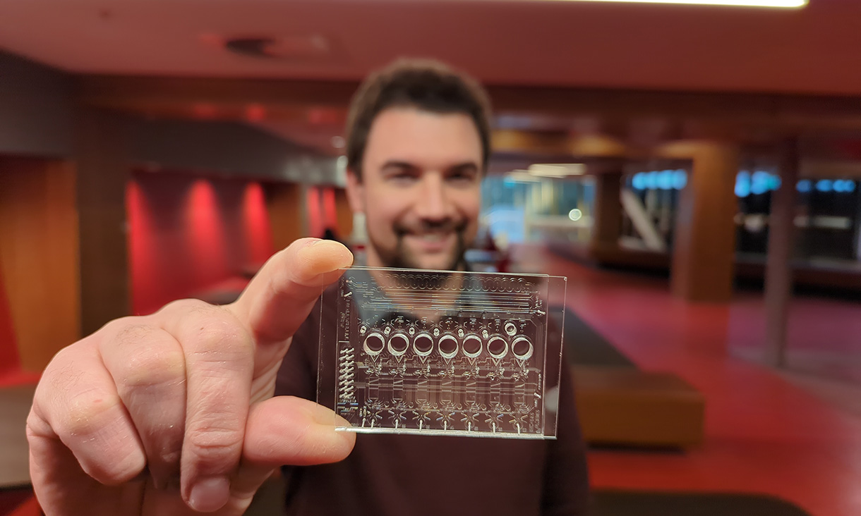 Dr Crispin Szydzik with complex microfluidics