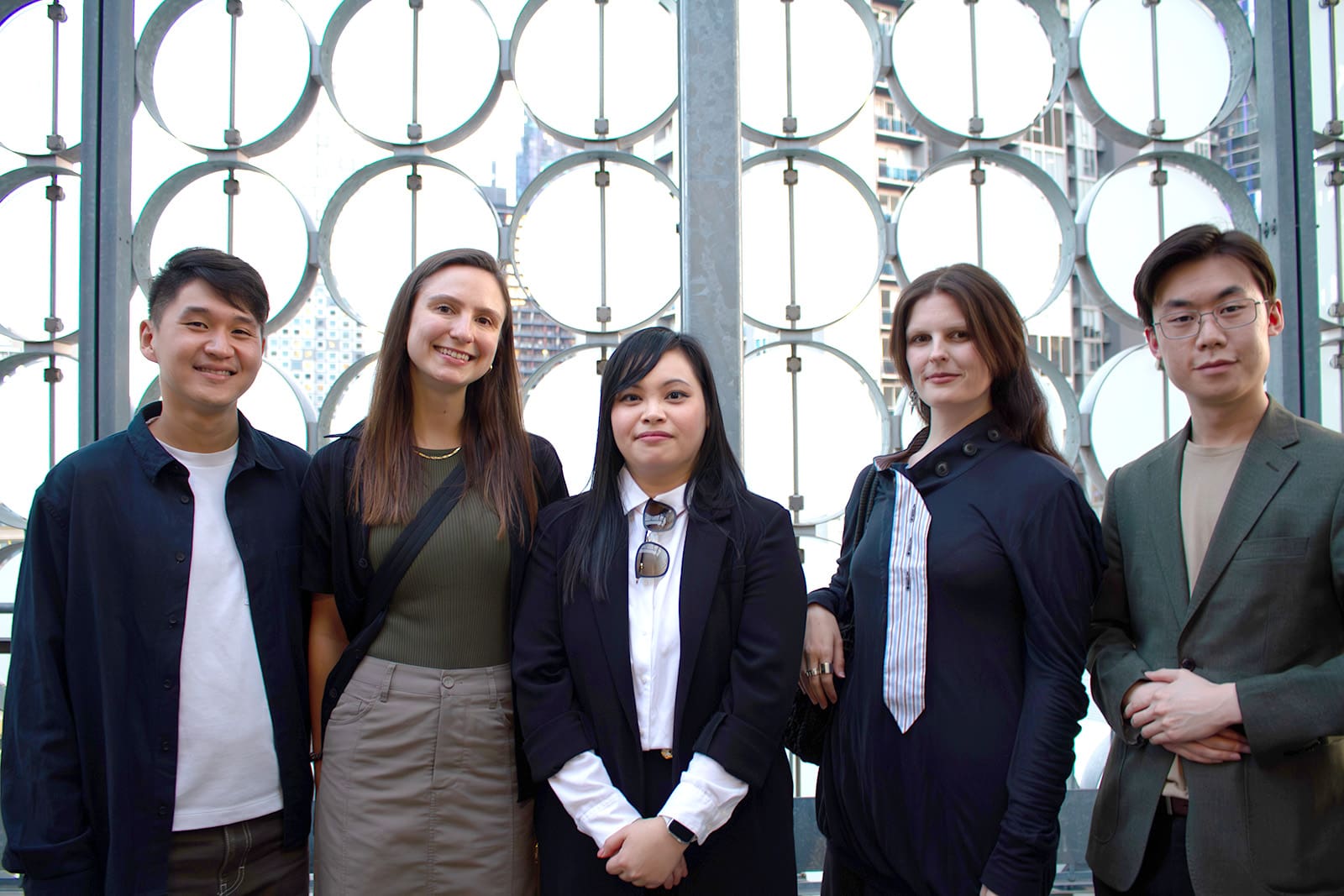 Five alumni standing together on the rooftop of the RMIT Design Hub