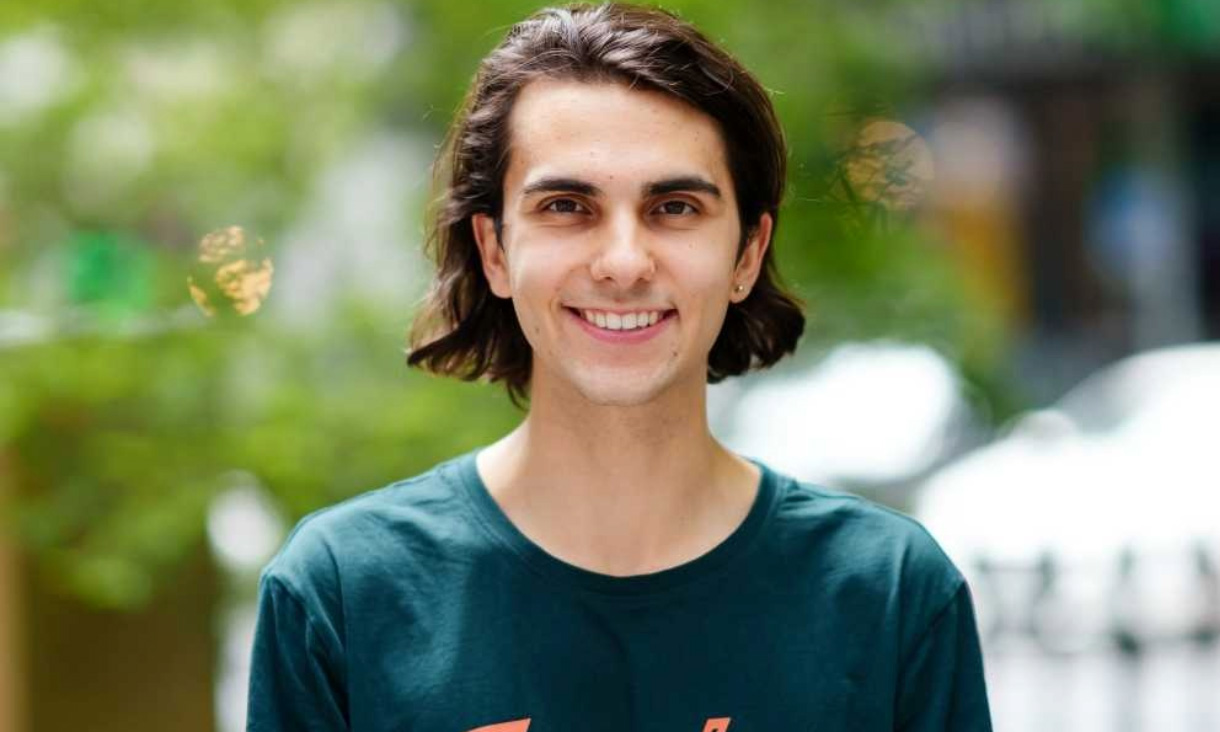 Oisin smiles at the camera.