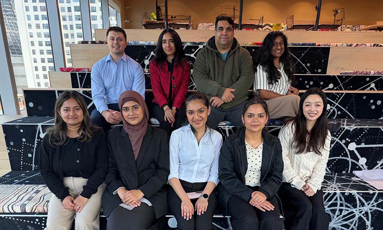 Group of people sitting together smiling at the camera.
