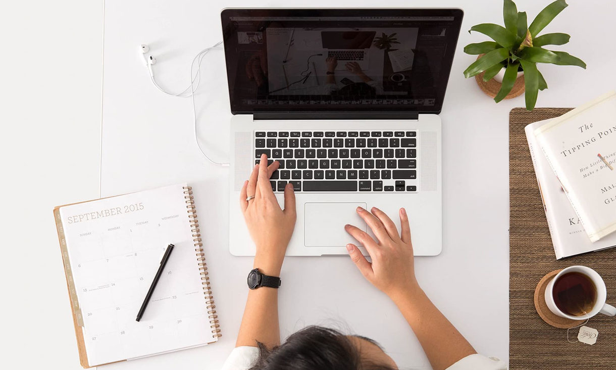 Overhead image of a girl on a laptop.
