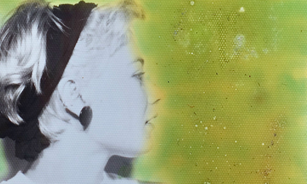 Black and white profile of a woman in a headband and earrings against a green and yellow painted background.