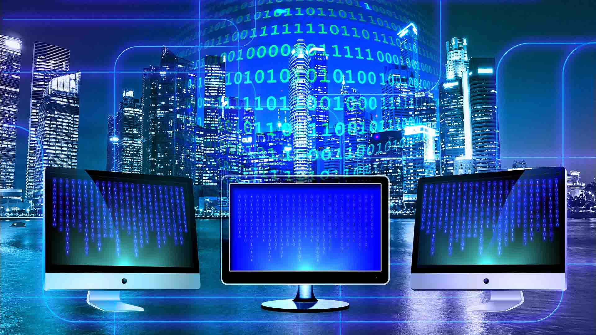 three computer monitors