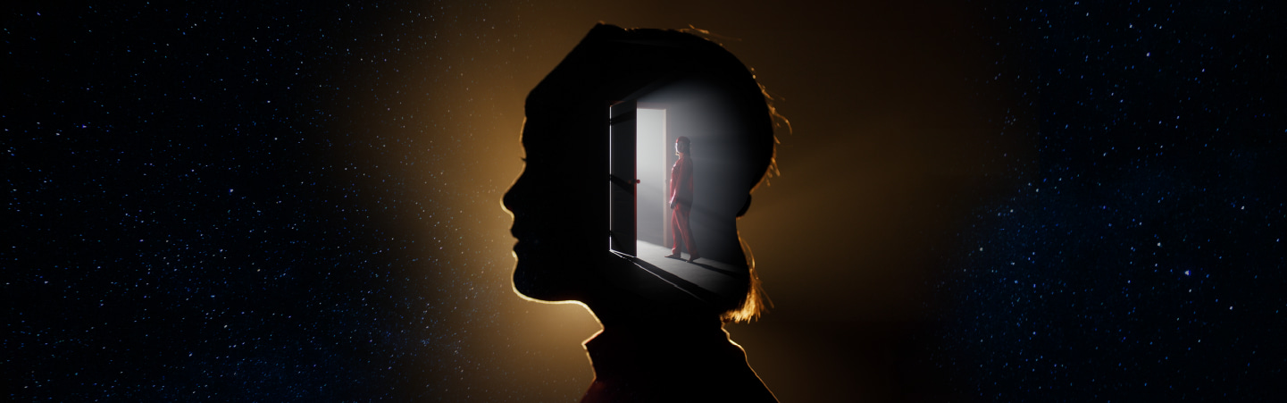 A silhouetted head reveals a glowing doorway within, where a figure in red stands poised at the threshold.