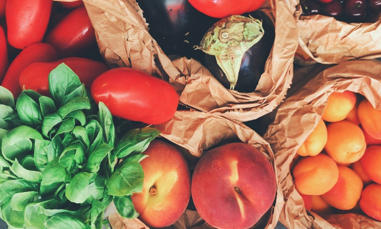 Fruit, vegetables and herbs in paper bags