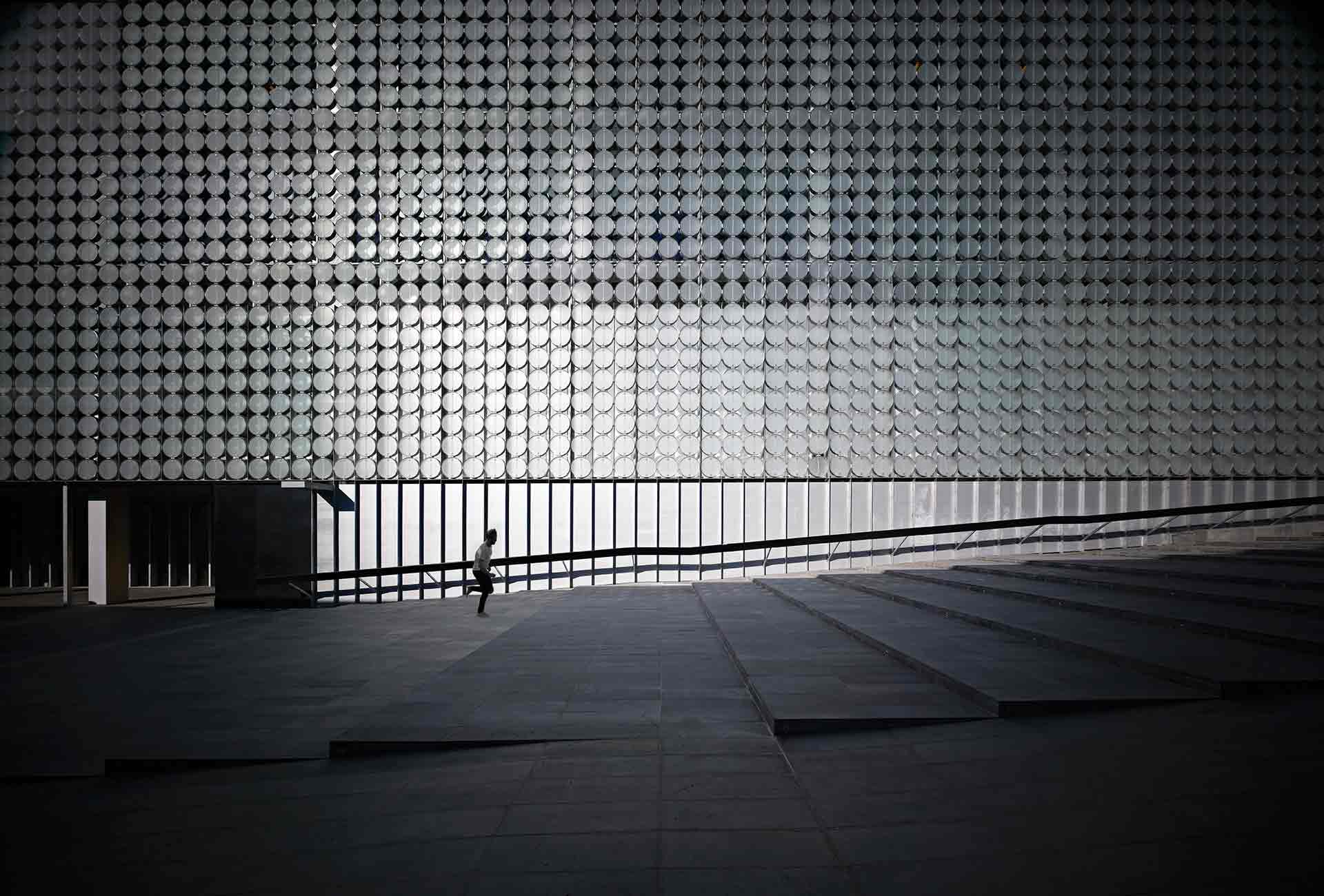 Person walking up steps of Design Hub building