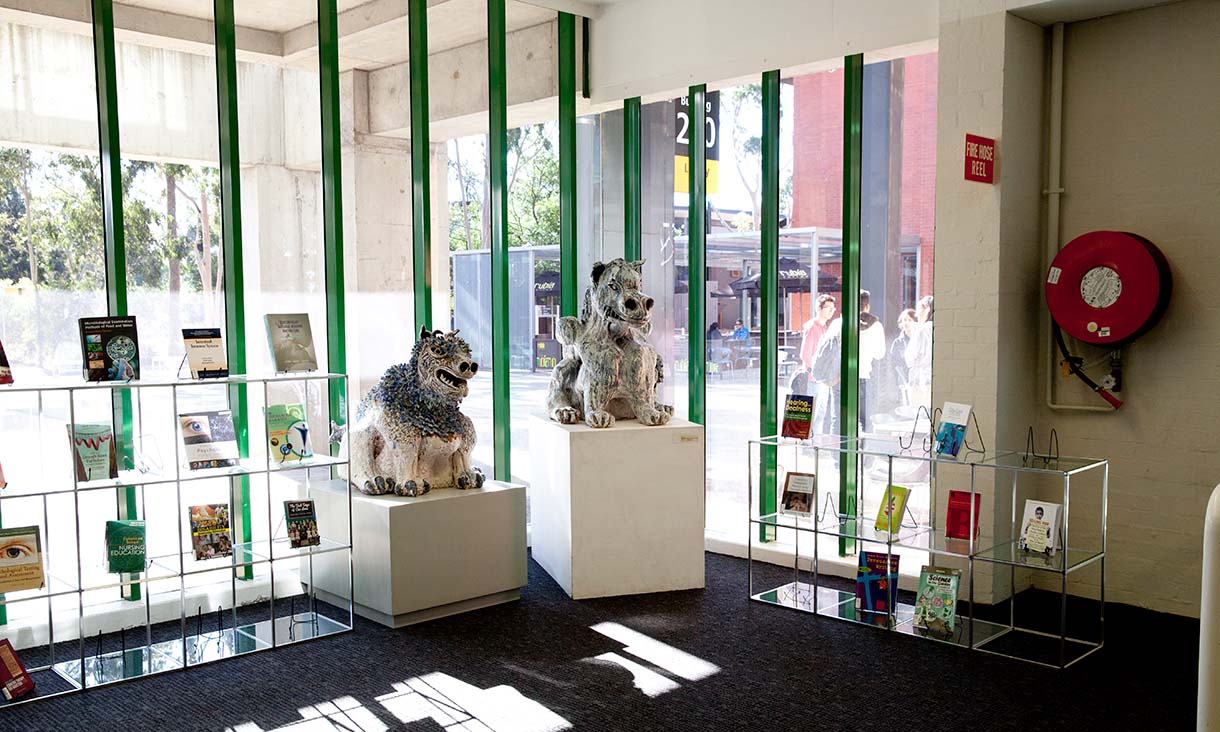 Bundoora Library book and sculpture displays near the entrance.