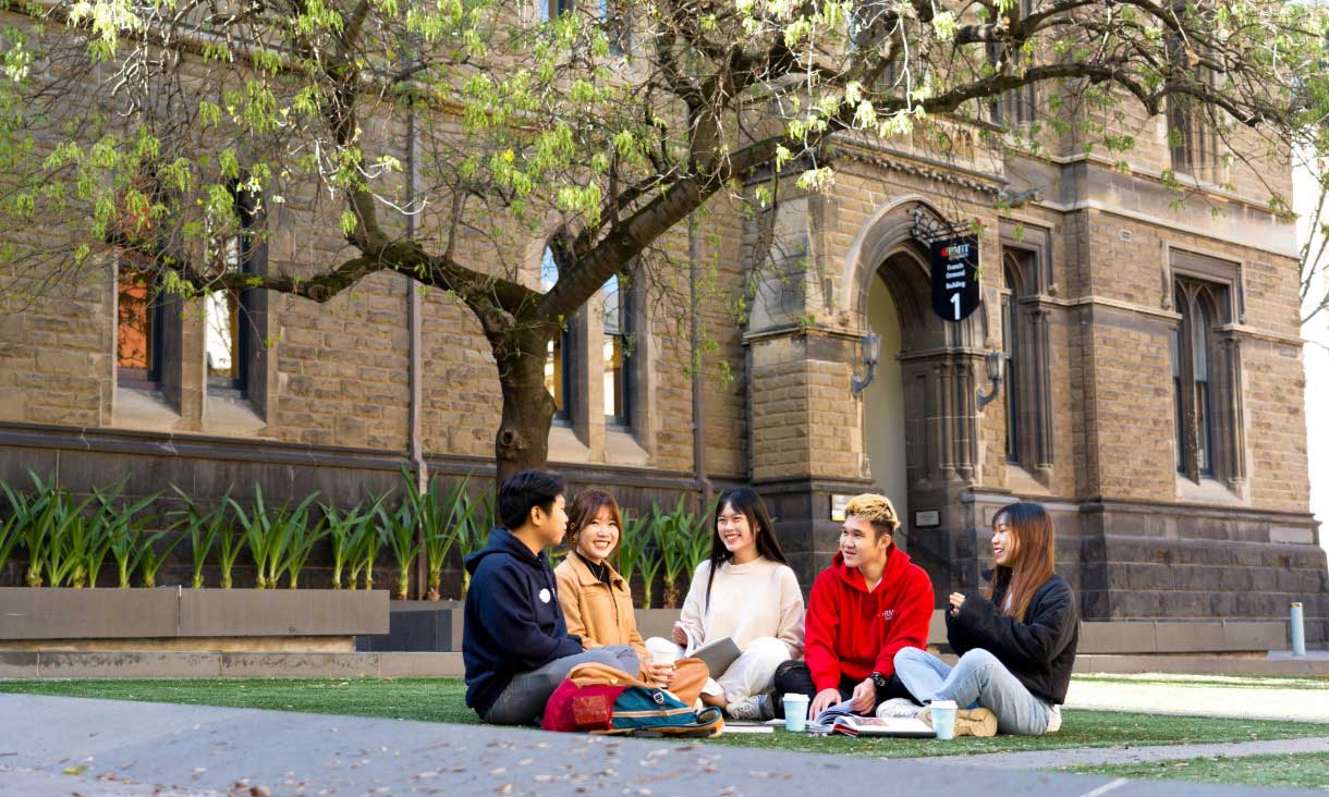 Students sit in a semicircle talking outside
